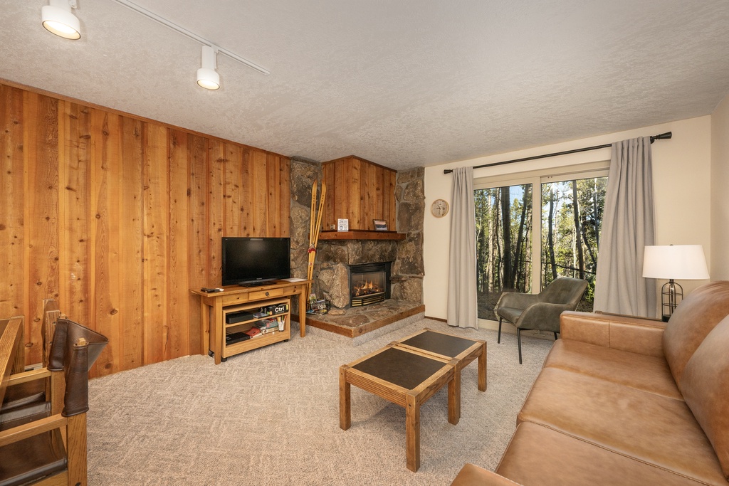 Cozy up by your crackling stone fireplace while enjoying tree views from your comfortable leather seating.