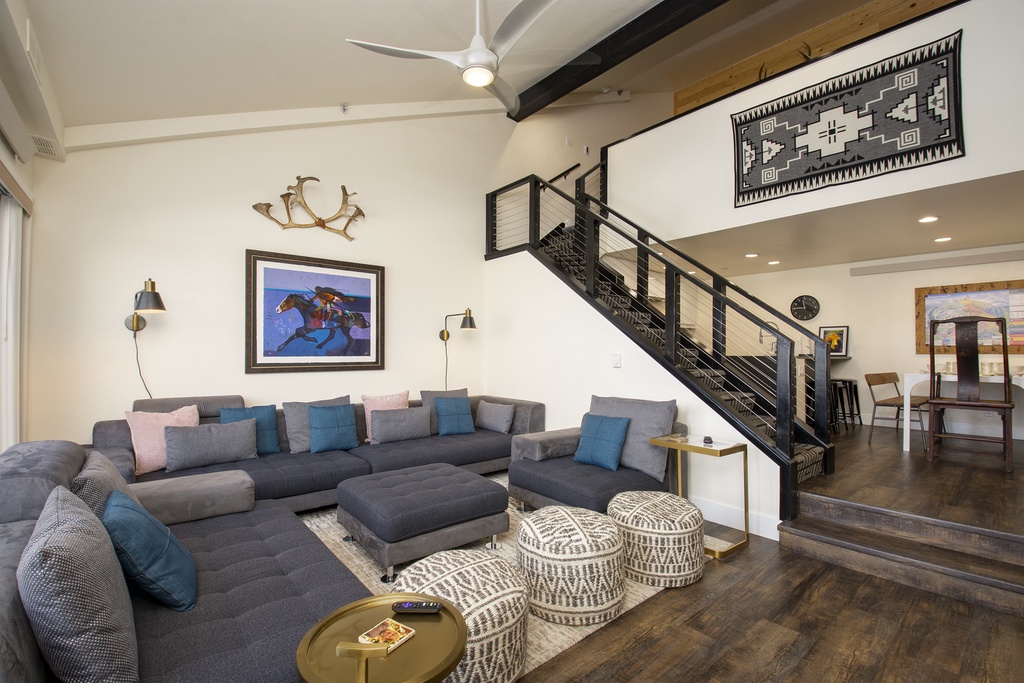 Stretch out on this spacious sectional sofa in your stylish living area, where exposed beams and Southwestern art create a warm, inviting atmosphere.