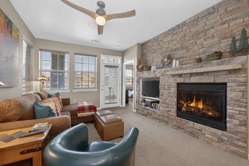 Sink into plush seating and watch the fire crackle in your cozy living room, where natural light and mountain charm invite you to unwind after a day of adventure.