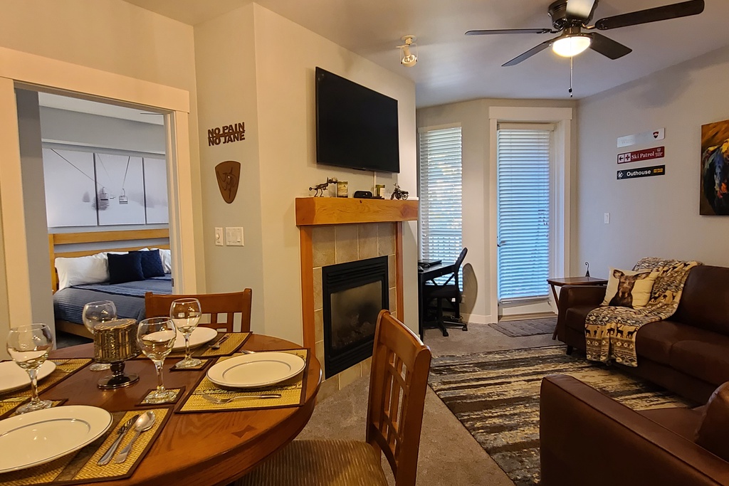 Unwind in your cozy living space featuring a warm fireplace, comfortable seating, and dining for memorable evenings together.