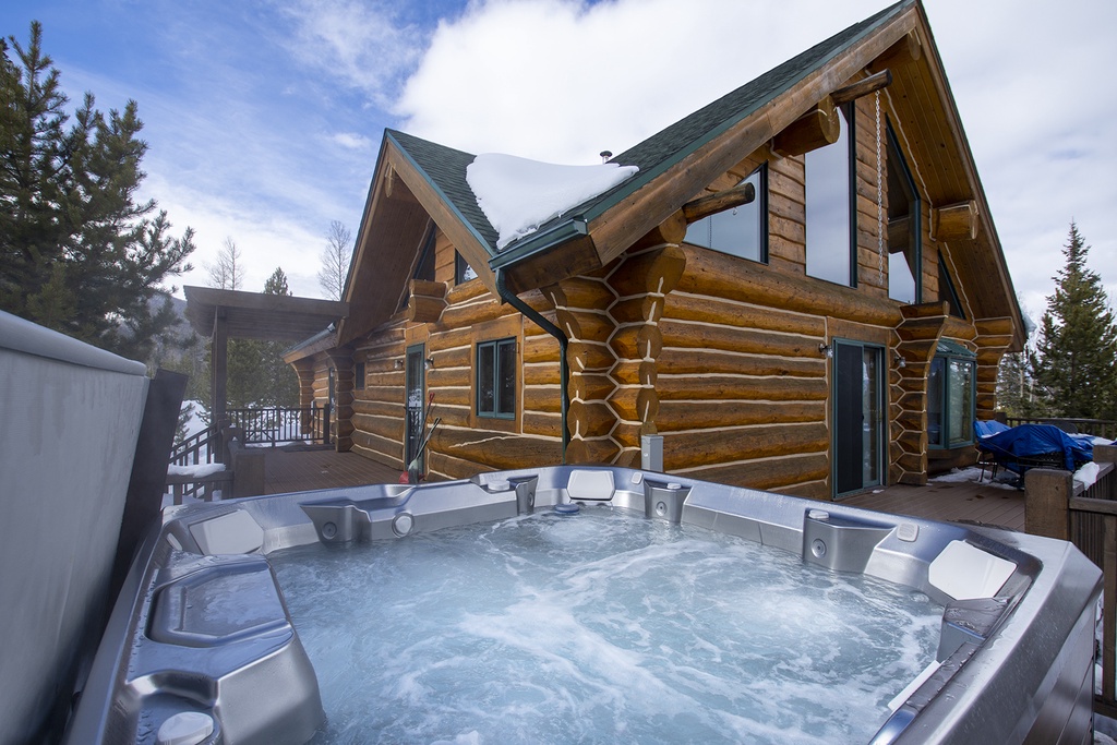 Soak in bubbling warmth while gazing at snow-dusted pines and dramatic mountain skies from your private hot tub.