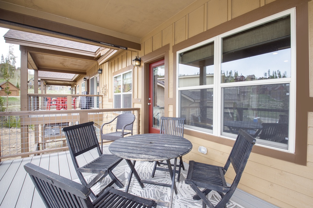 Your private balcony awaits with a charming table set for four, where you can savor morning coffee or evening wine while taking in peaceful mountain views.