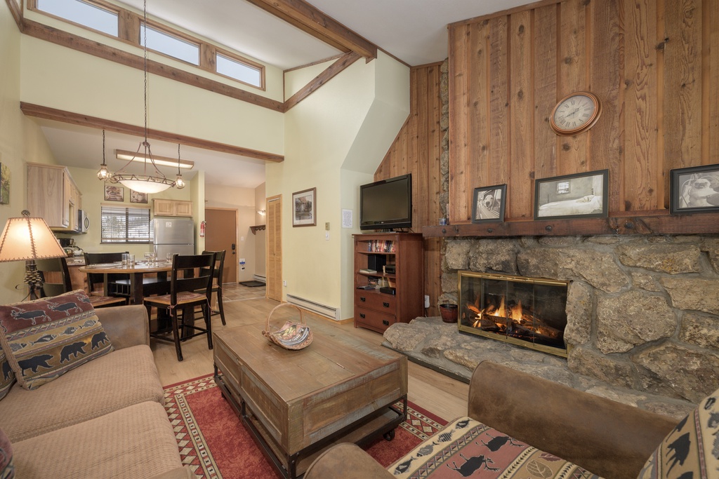 Cozy up by your stone fireplace while natural light streams through vaulted ceilings in this warm mountain retreat.
