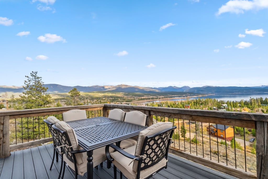 Mountain and lake views stretch endlessly from this elevated deck dining space, creating the perfect outdoor retreat at 128 GCR 4034.