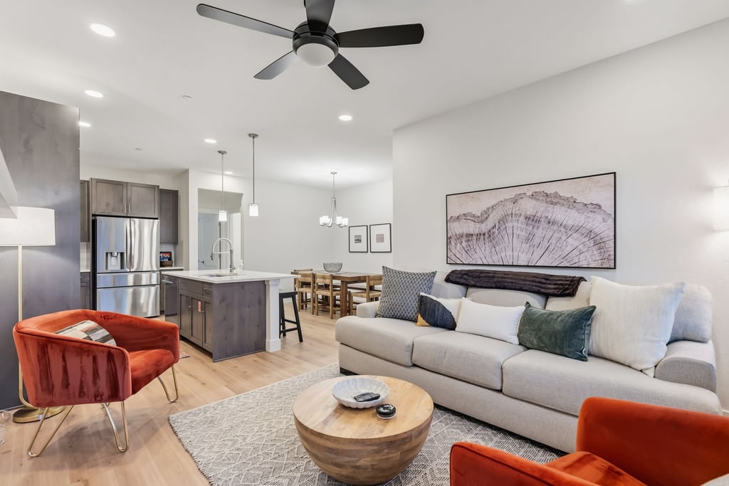 Unwind in your stylish open-plan living space with plush seating and vibrant pops of color.