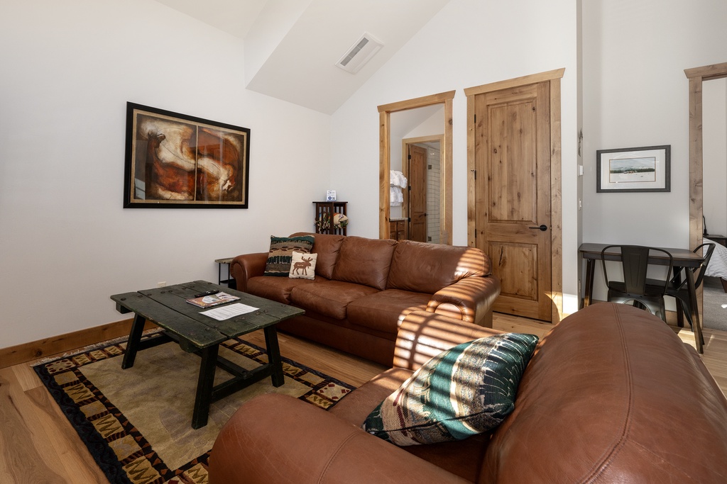 Sink into rich leather seating where warm sunlight streams through, creating the perfect spot for your morning coffee or evening relaxation.