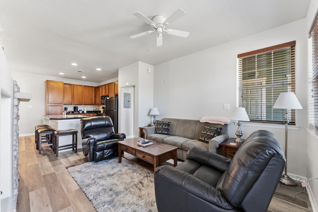 Unwind in your spacious open-concept living space with plush leather seating and a fully equipped kitchen for cooking together.