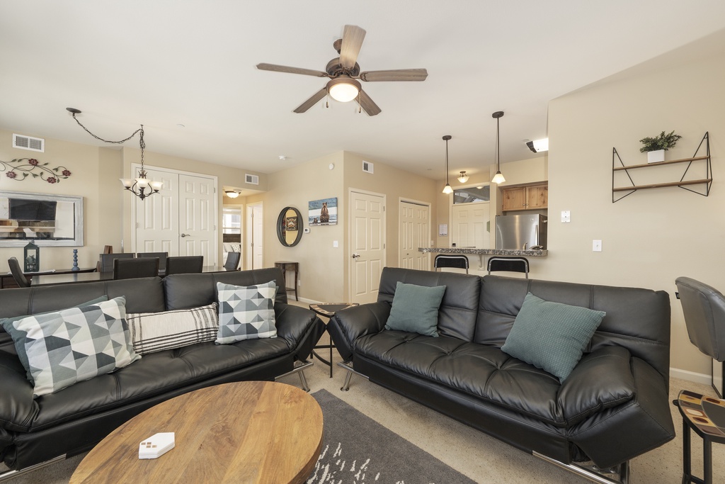 Sink into plush leather sofas in your open-concept living space, where modern comfort meets home-style convenience.