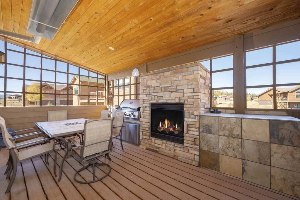 Gather around your private fireplace while dinner sizzles on the grill in this stunning covered terrace with mountain views.