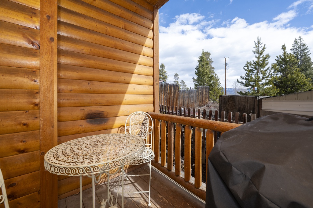 Step onto your private balcony at Granby Lake Shore Estates Townhome 5 where mountain air mingles with the warmth of natural wood, creating the perfect spot for morning coffee.