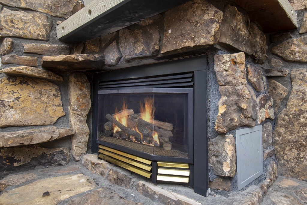 Gather around this beautiful stone fireplace where crackling flames create the perfect ambiance for cozy evenings together.