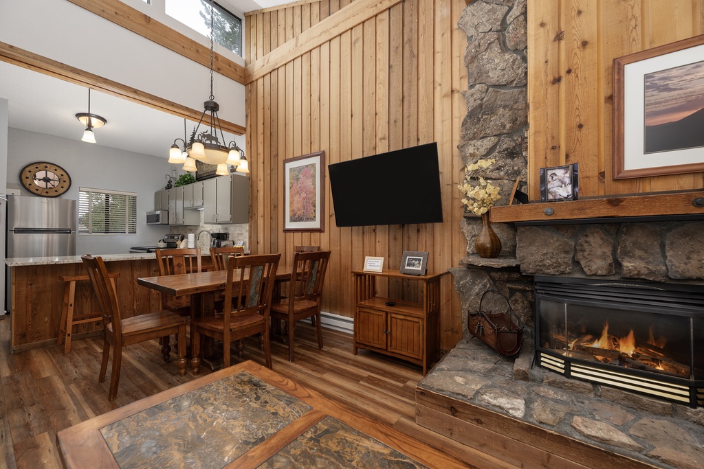 Cozy up by your crackling stone fireplace while enjoying mountain lodge comfort with warm wood accents and open-concept living.