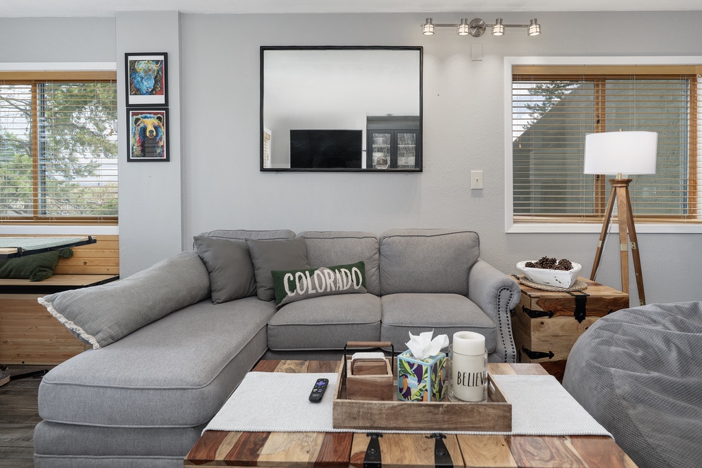 Sink into the plush sectional sofa where you'll unwind with your favorite shows on the wall-mounted TV in this thoughtfully designed living space.