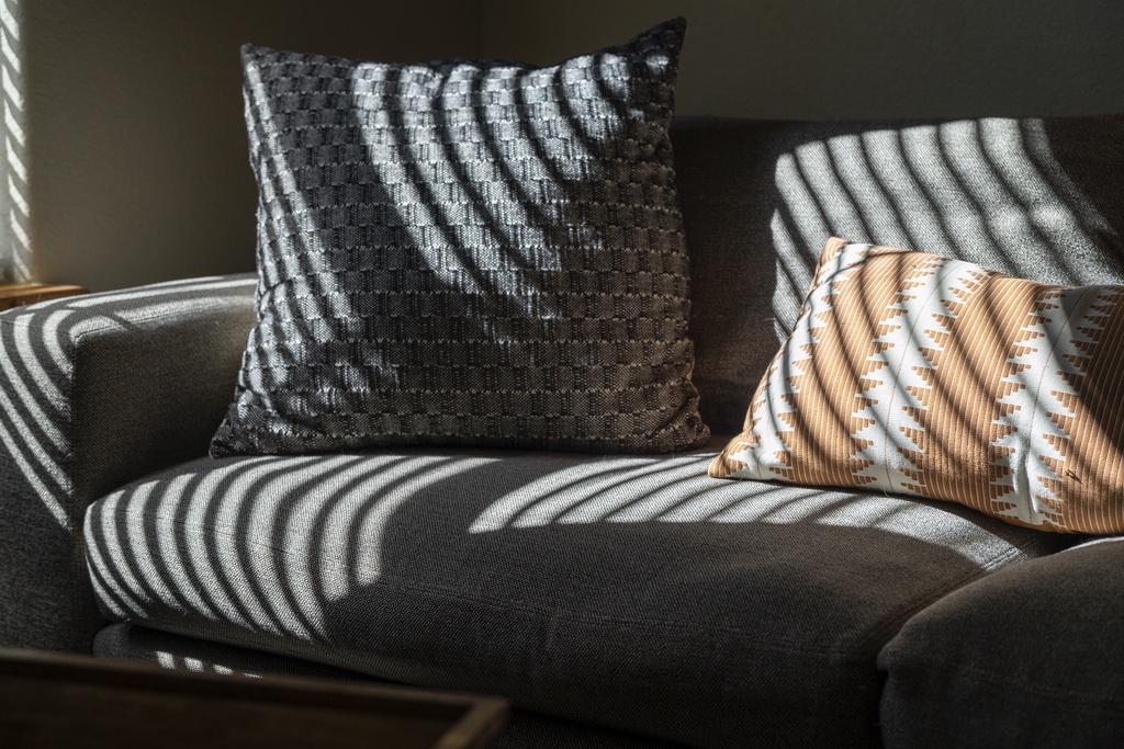 Sink into plush comfort with elegant throw pillows catching soft natural light—your perfect spot to unwind after exploring the area.