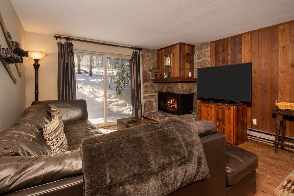 Curl up on plush leather seating by your crackling fireplace, watching snow fall through the window in this cozy mountain retreat.