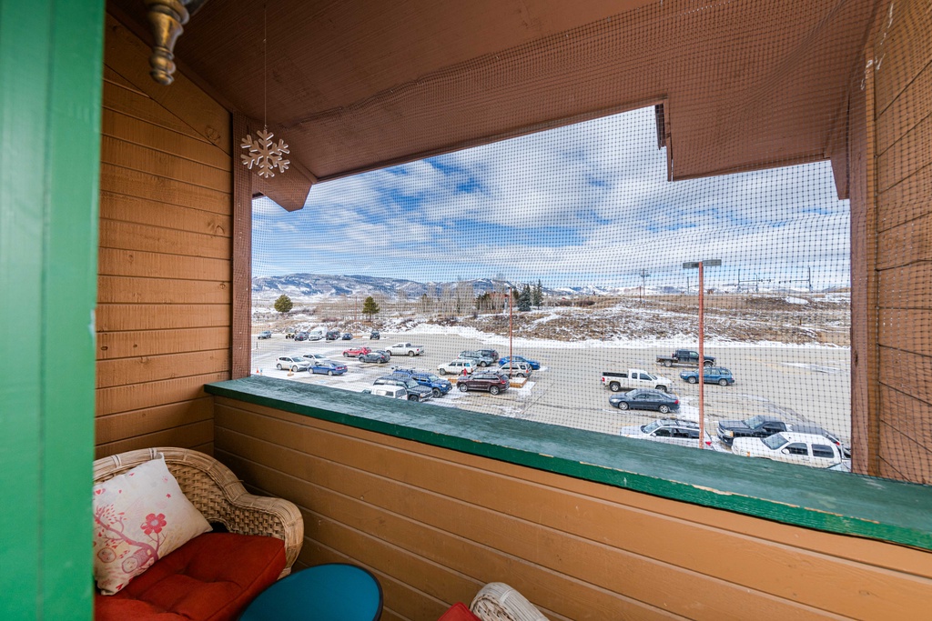 Your private mountain balcony at 645 SilverCreek Inn offers stunning snow-capped views and colorful seating for morning coffee or evening relaxation.