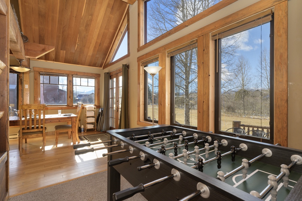 Challenge friends to foosball matches in this sun-drenched game room, where floor-to-ceiling windows frame mountain views.