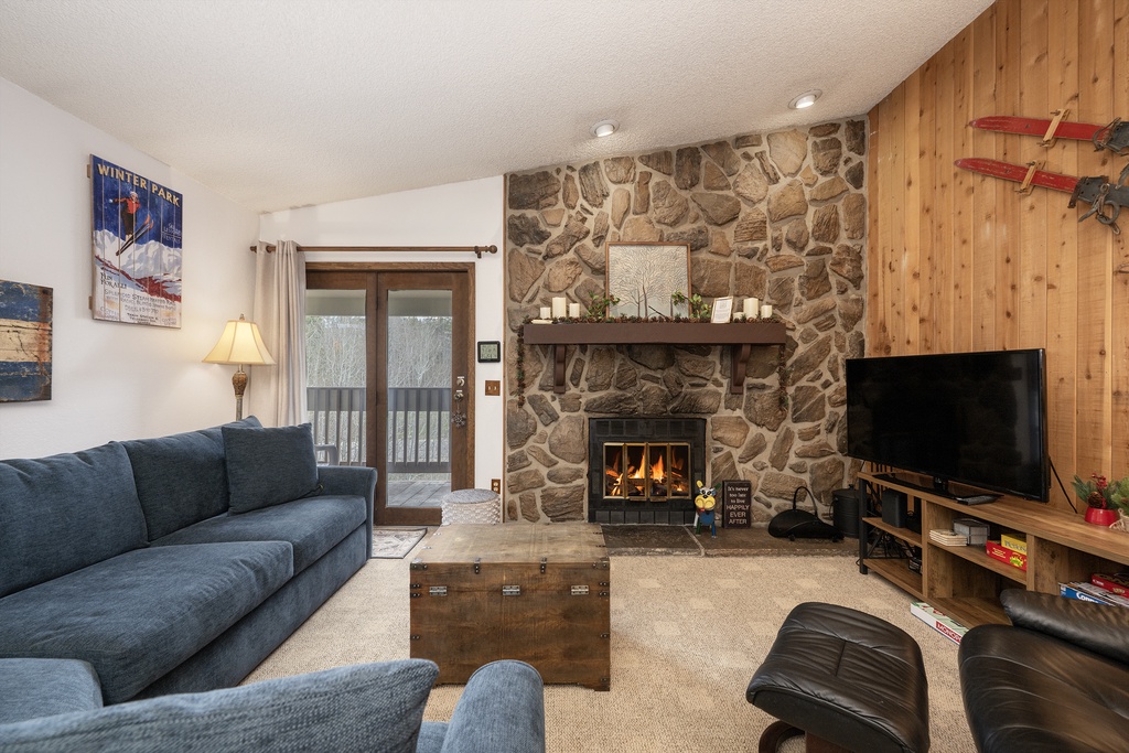 Cozy up in this inviting living room where crackling flames and plush seating create your perfect mountain retreat sanctuary.