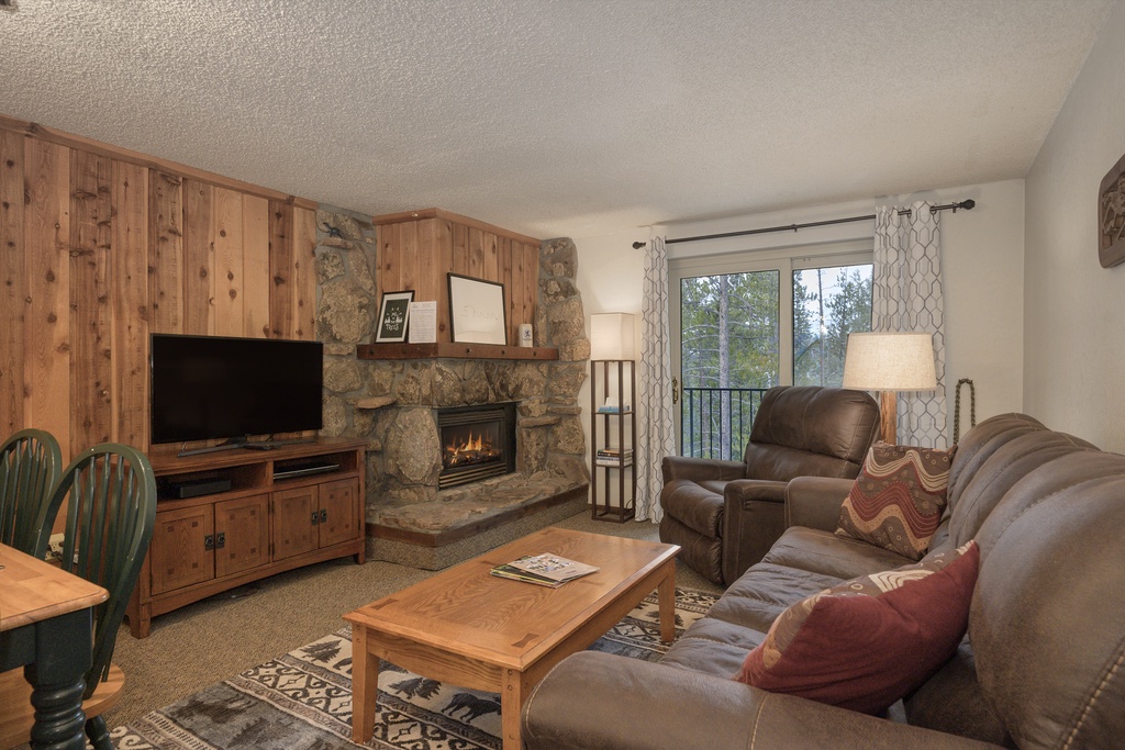 Cozy up by your crackling stone fireplace while watching your favorite shows on the flat-screen TV in this warm mountain retreat.