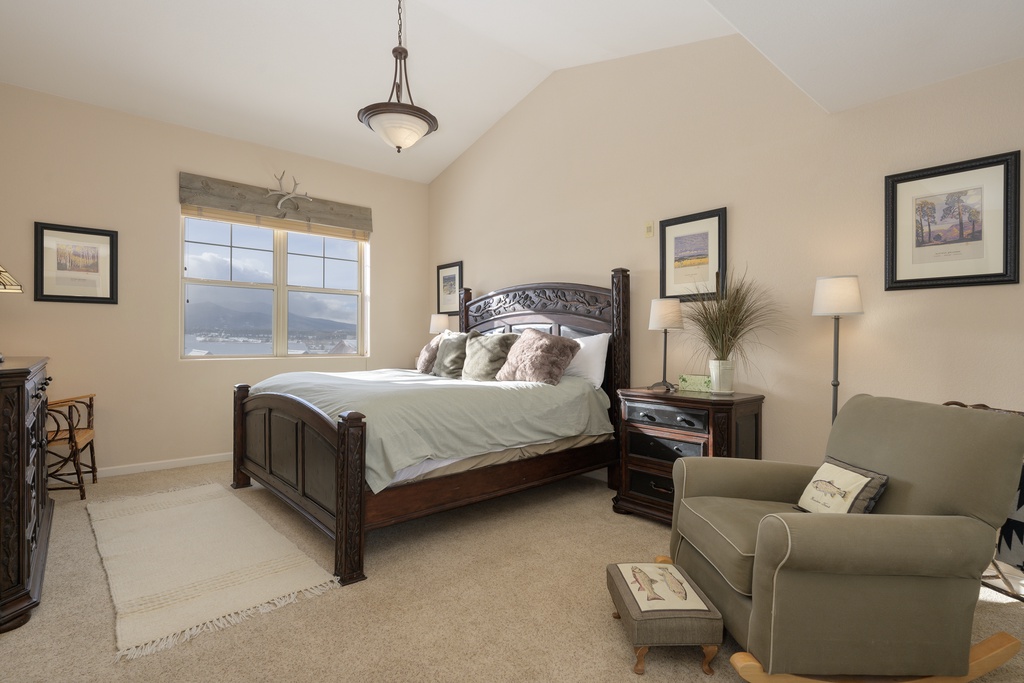 Relax in your serene bedroom with mountain views, plush bedding, and cozy seating area for quiet moments.