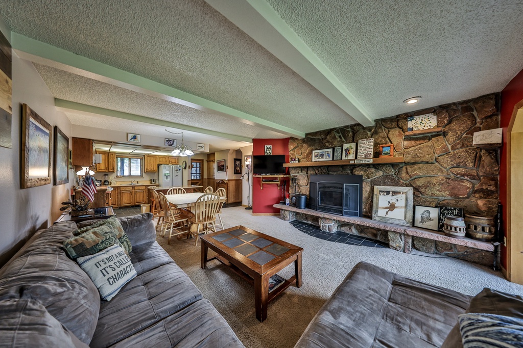Sink into comfortable seating by your beautiful stone fireplace while enjoying the open-concept space that flows into your fully equipped kitchen.