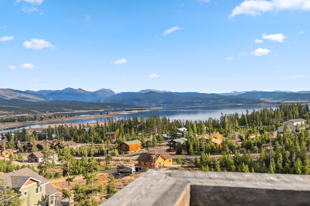 Elevated lakeside community surrounded by mountain peaks and evergreen forests, offering scenic natural beauty and peaceful residential setting.