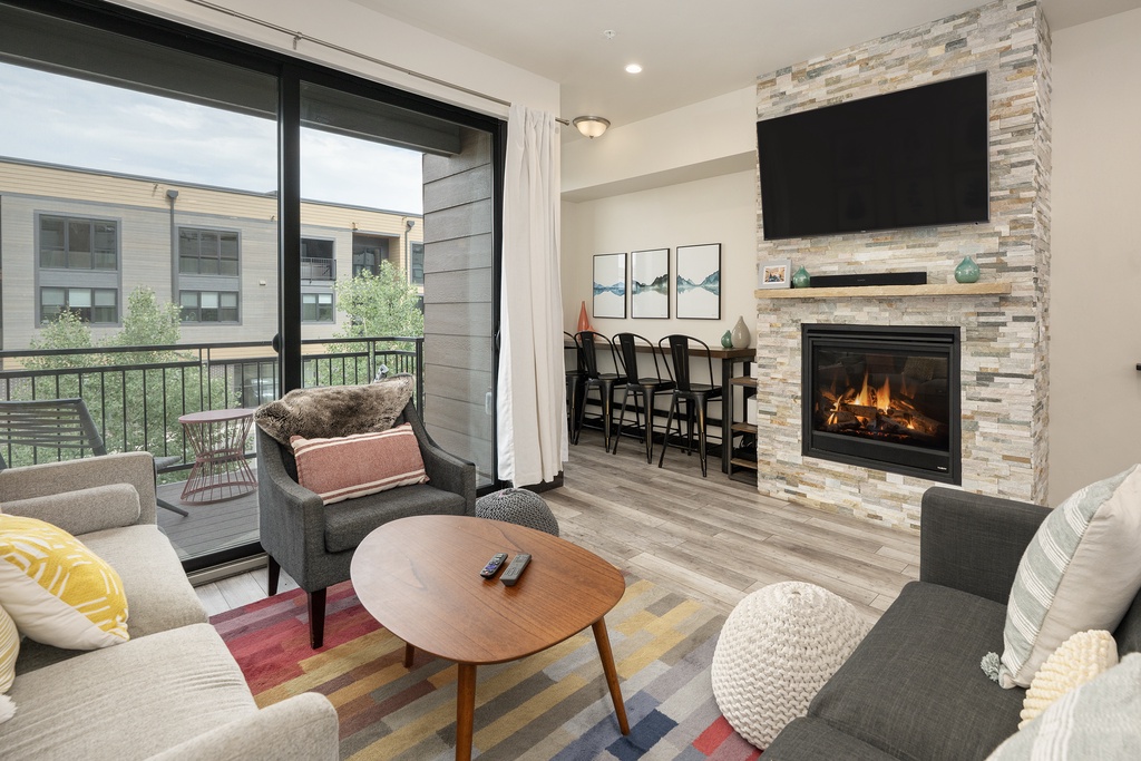 Unwind by your cozy fireplace while enjoying views of the courtyard, with modern dining and entertainment at your fingertips.