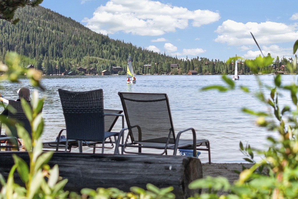 Picture yourself unwinding in your own lakeside lounge chairs, watching sailboats glide by as mountain breezes ripple the water. Your peaceful escape awaits at the edge of this stunning alpine lake.