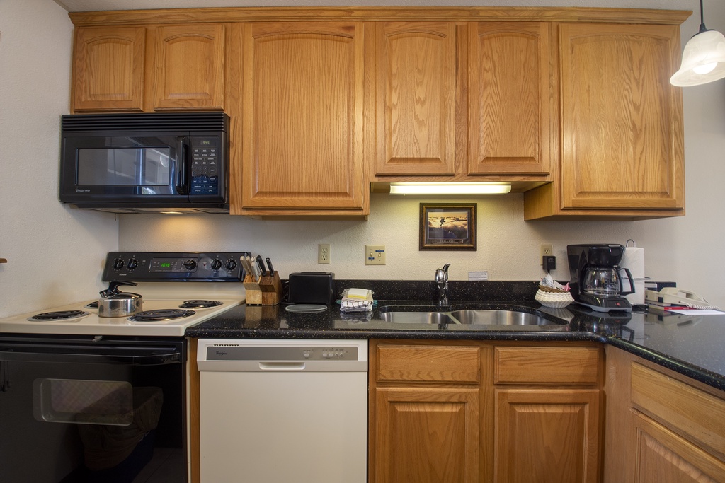 Your fully equipped kitchen features warm oak cabinets, granite countertops, and everything needed to prepare memorable meals during your stay.
