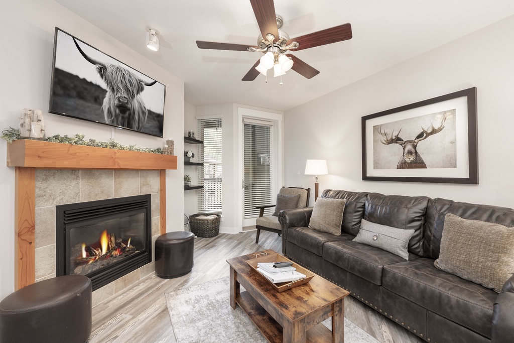 Cozy up in your stylish living room featuring a warm fireplace, plush leather seating, and thoughtful decor that creates the perfect mountain retreat atmosphere.