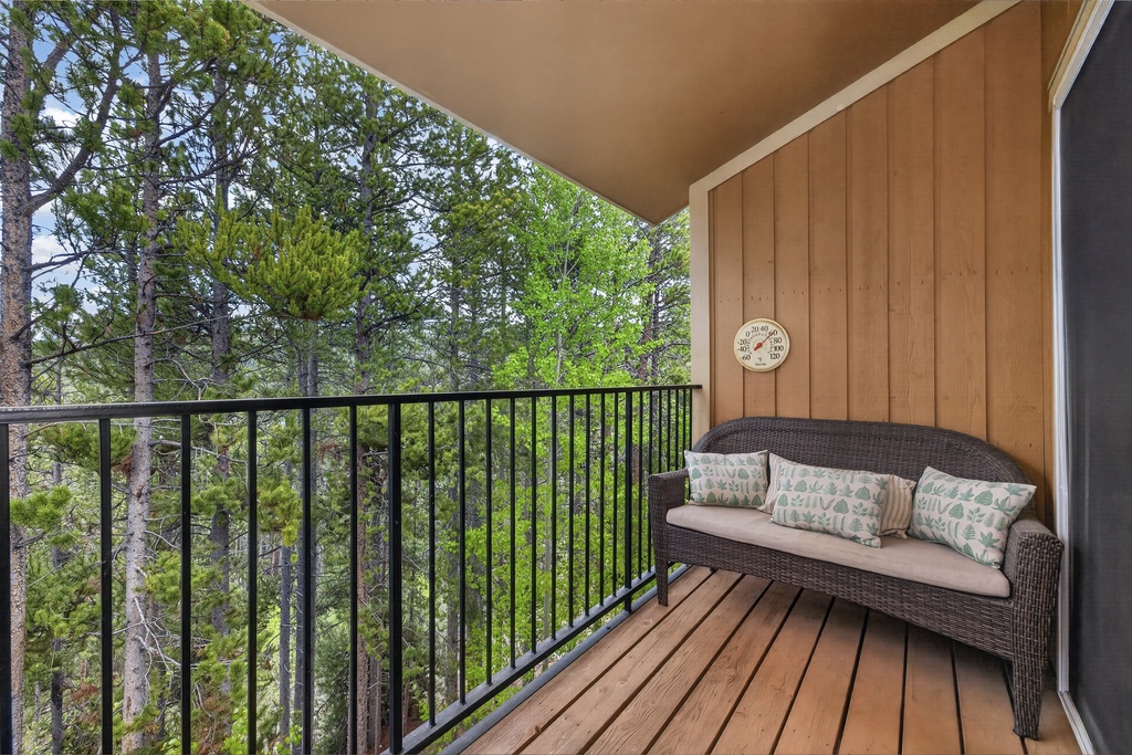 Settle into this cozy balcony nook and let the forest views refresh your spirit. With cushioned seating and lush greenery surrounding, it's your perfect spot to unwind.
