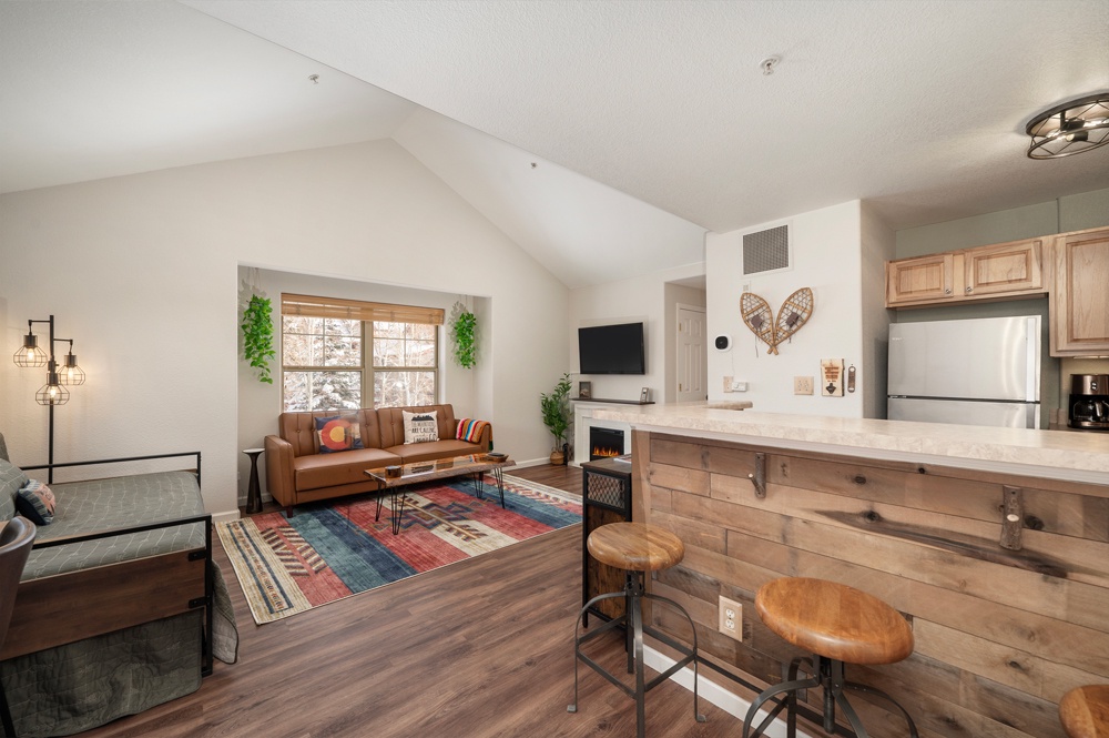 Cozy up in your mountain-inspired retreat with warm wood finishes, a crackling fireplace, and rustic charm throughout your open living space.