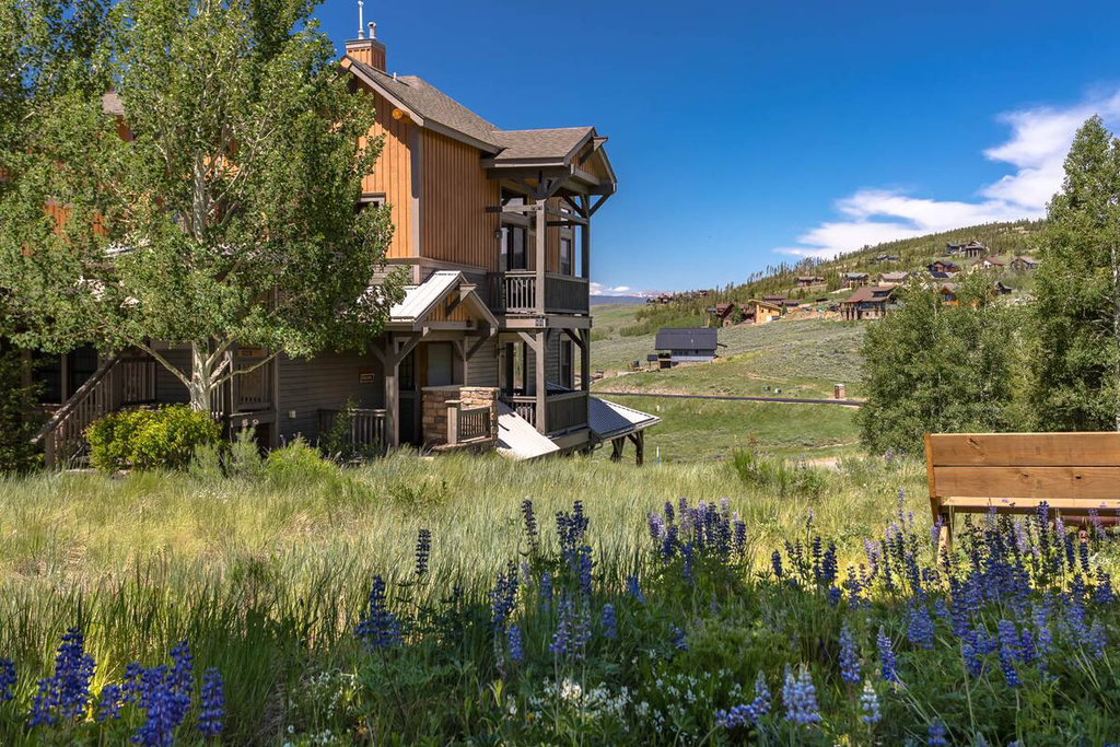 Kicking Horse Buckskin 3-205 is a modern mountain architecture showcases elegant wood and stone design in a peaceful residential setting.