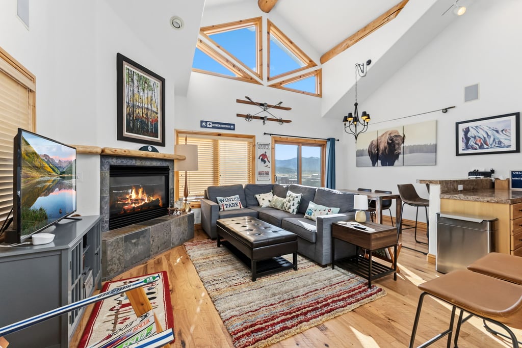 Cozy up by your crackling fireplace beneath vaulted ceilings and skylights that flood this inviting space with natural light and warmth.