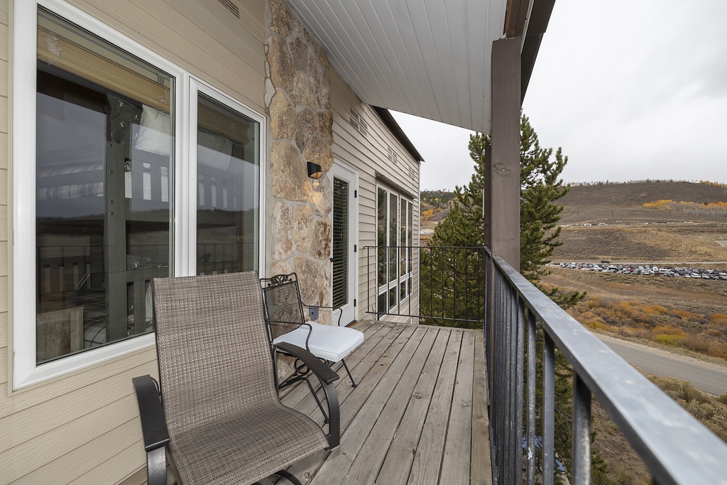 A covered deck overlooking expansive hillside terrain, perfect for quiet mornings with coffee or evening relaxation while taking in the natural surroundings.
