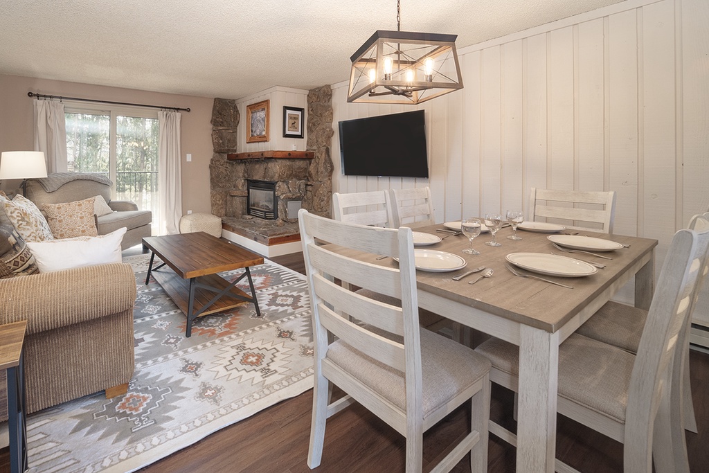 Gather around your dining table for memorable meals, with a cozy living area and warm fireplace creating the perfect atmosphere for relaxing evenings.