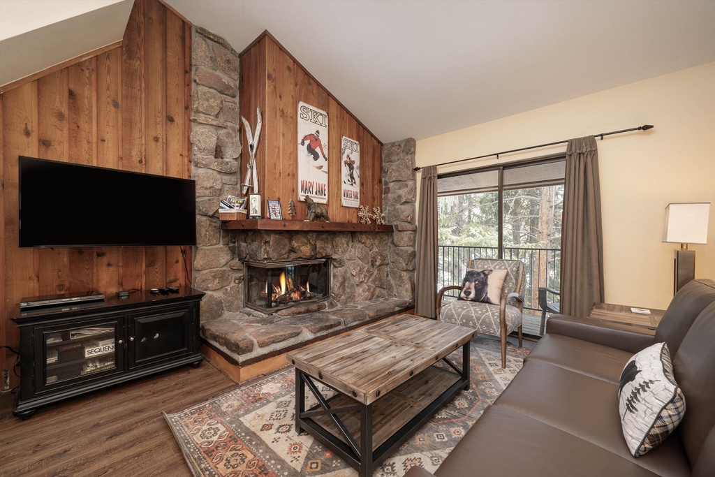 Cozy up by your crackling stone fireplace while enjoying mountain views from your private balcony in this rustic alpine retreat.