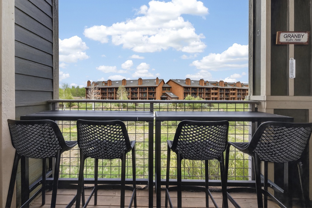 Perched at high elevation, this mountain town balcony offers a peaceful spot to enjoy coffee and watch the clouds drift over the scenic alpine landscape.