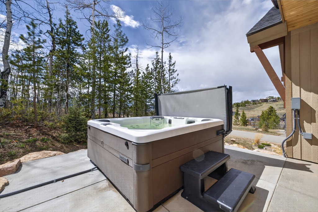 Soak away your cares in this private hot tub, surrounded by towering pines and mountain views—your perfect retreat after a day of adventure.