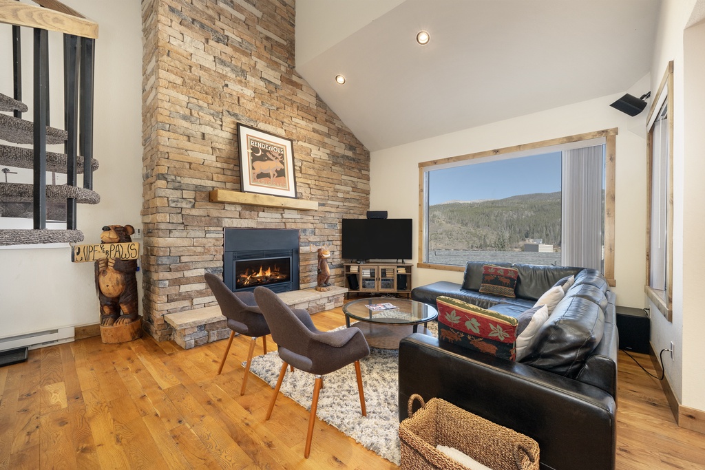 Cozy up by your crackling fireplace while soaking in stunning mountain views through floor-to-ceiling windows.