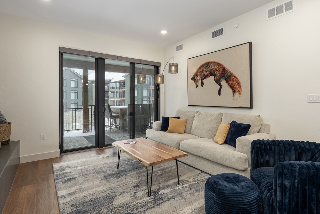 Unwind in this stylish living room with modern furnishings, where natural light flows through your private balcony doors.