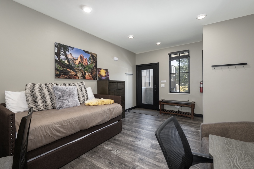 Relax on your comfortable daybed while enjoying mountain views from your window in this modern, thoughtfully designed space.