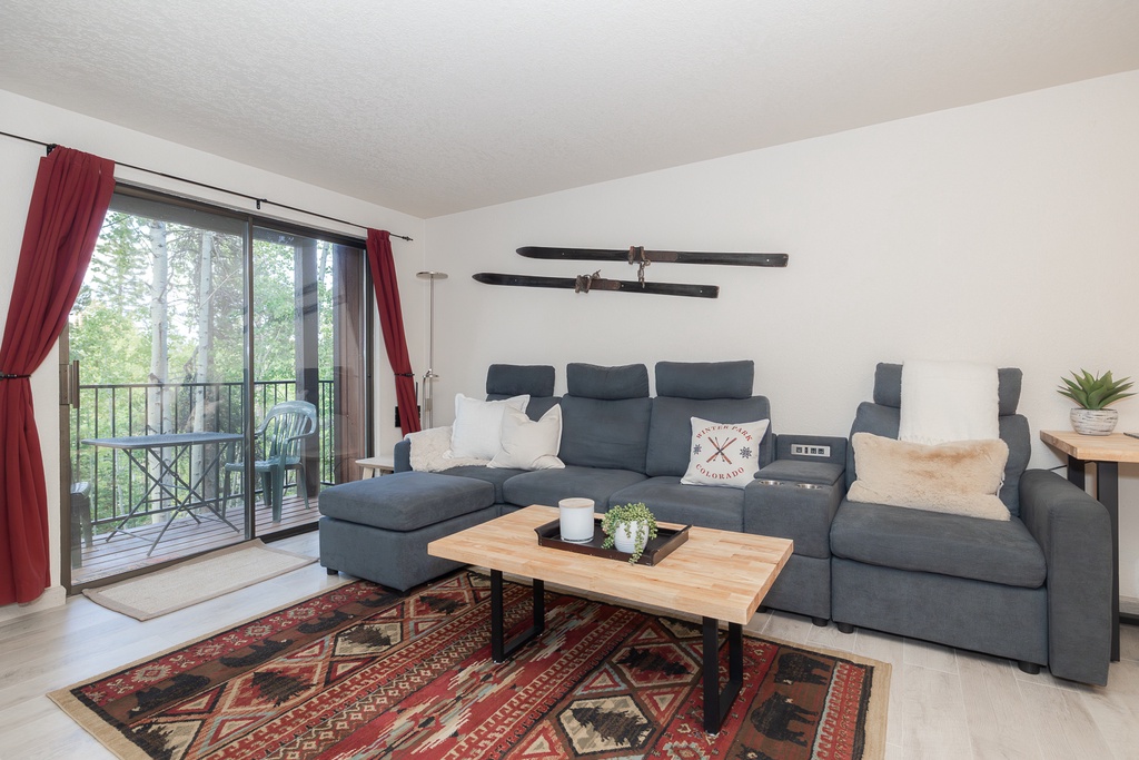 Sink into this cozy sectional and unwind while your private balcony offers peaceful forest views through floor-to-ceiling windows.