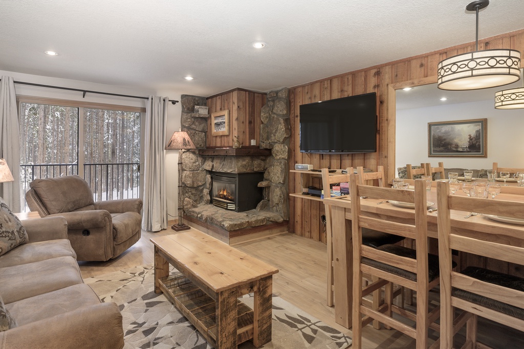 Cozy up by your stone fireplace while snow falls outside, creating the perfect winter retreat atmosphere.