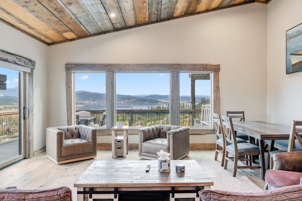 Relax in your rustic-chic living space with exposed beam ceilings, mountain views, and thoughtfully arranged seating perfect for morning coffee.