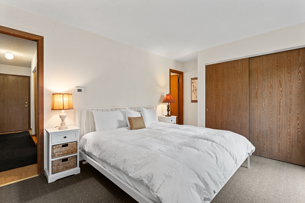 Drift off in your serene bedroom, where a plush bed awaits beneath soft lighting. Ample storage and calming tones create your perfect restful retreat.