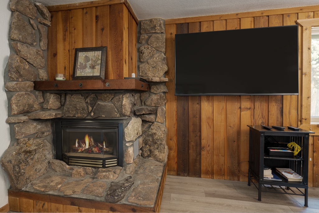 Cozy up by your stone fireplace while enjoying your favorite shows on the large flat-screen TV in this warm, rustic retreat.