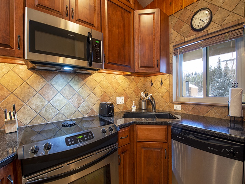 Step into your fully equipped kitchen, complete with granite counters and warm wood cabinetry for effortless meal prep.