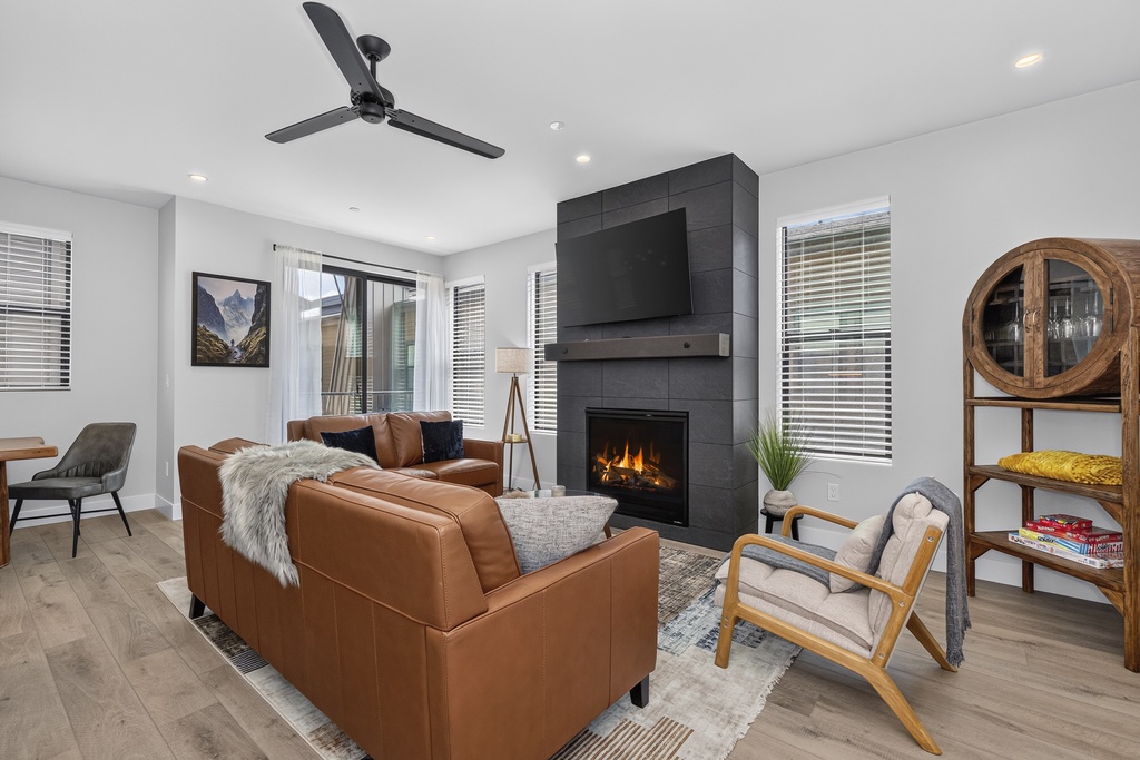 Sink into the plush leather seating and let the warmth of your gas fireplace embrace you in this thoughtfully designed living space, where modern comfort meets mountain charm.