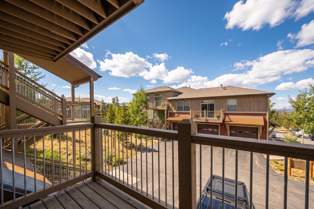 Mountain resort property surrounded by summer landscape and clear blue skies.